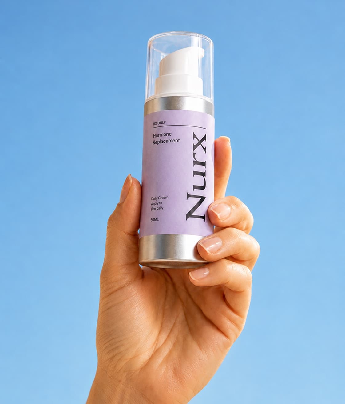 A hand holding a bottle of Nurx daily hormone cream